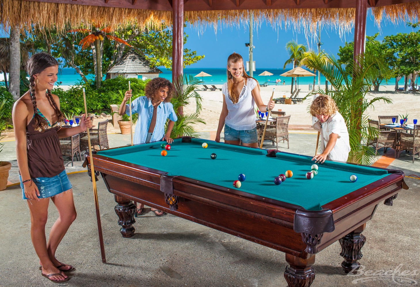 Teens playing pool at Beaches Negril Resort