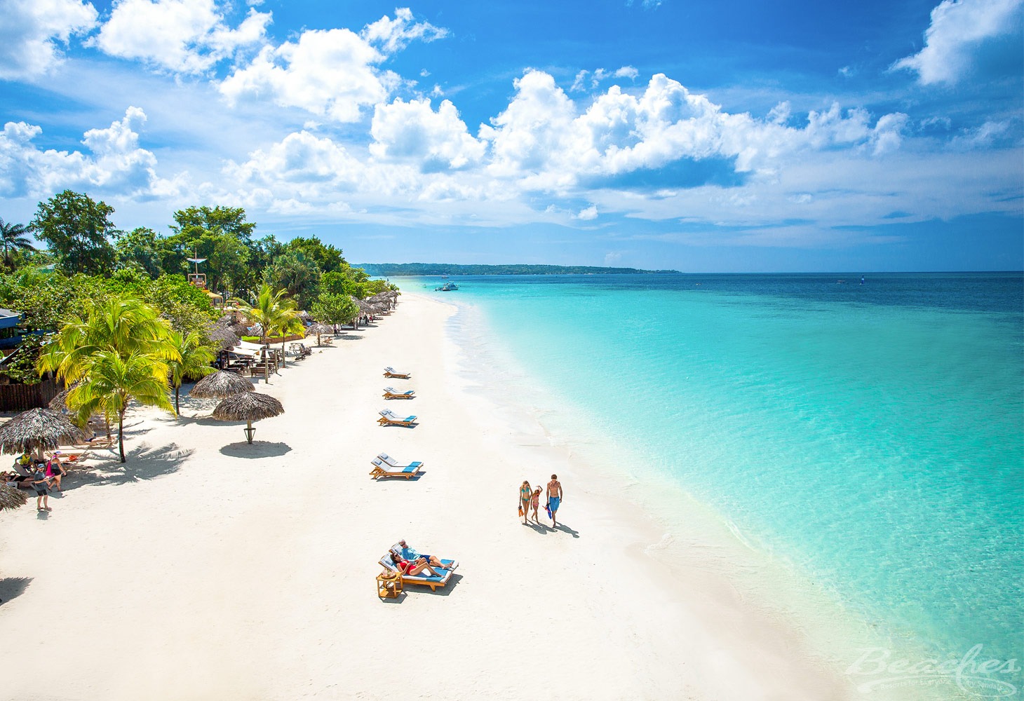 Family walking on beach at Beaches Negril Resort & Spa