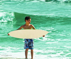 boy surfing the waves in Panama City Beach Florida